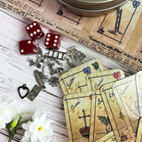 This is a unique divination system all in one tinned kit.  It is based upon tea leaf reading and Alice in Wonderland theme. It has a washable spandex mat and 18 mini cards and 18 charms and 3 dice.