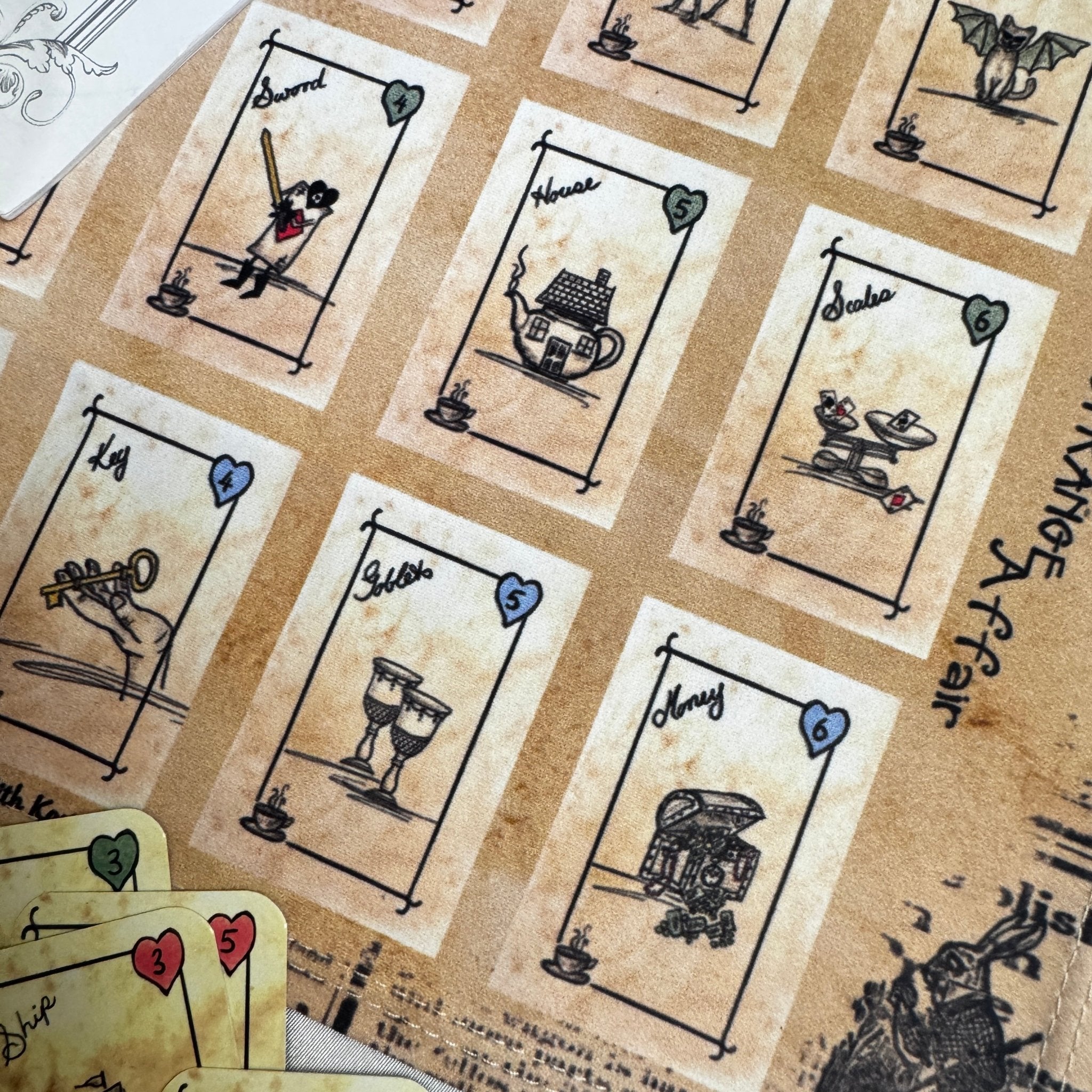 This is a unique divination system all in one tinned kit.  It is based upon tea leaf reading and Alice in Wonderland theme. It has a washable spandex mat and 18 mini cards and 18 charms and 3 dice.