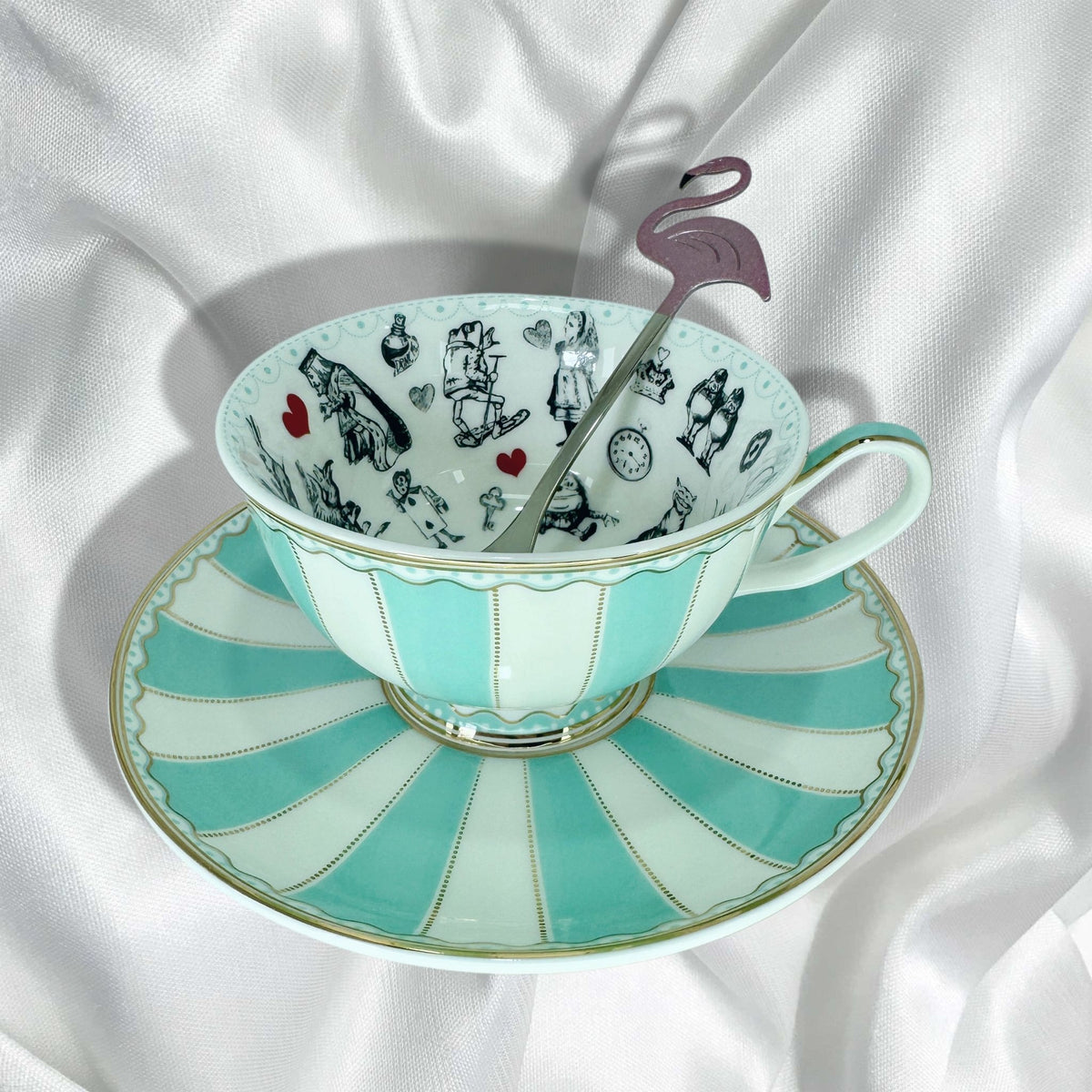 Full view of the Alice in Wonderland teacup and saucer set with the flamingo teaspoon