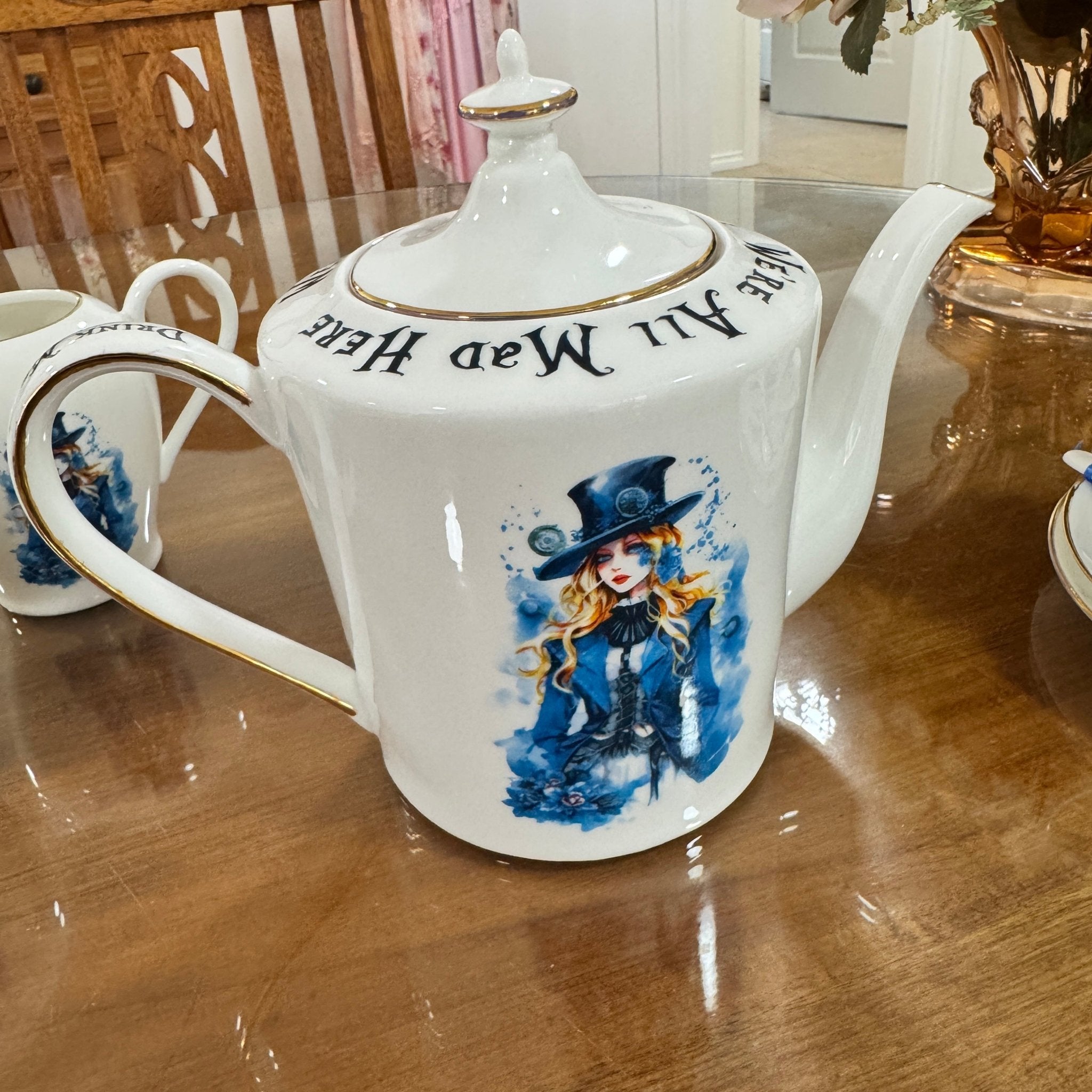 White teapot with artistic design on a wooden table