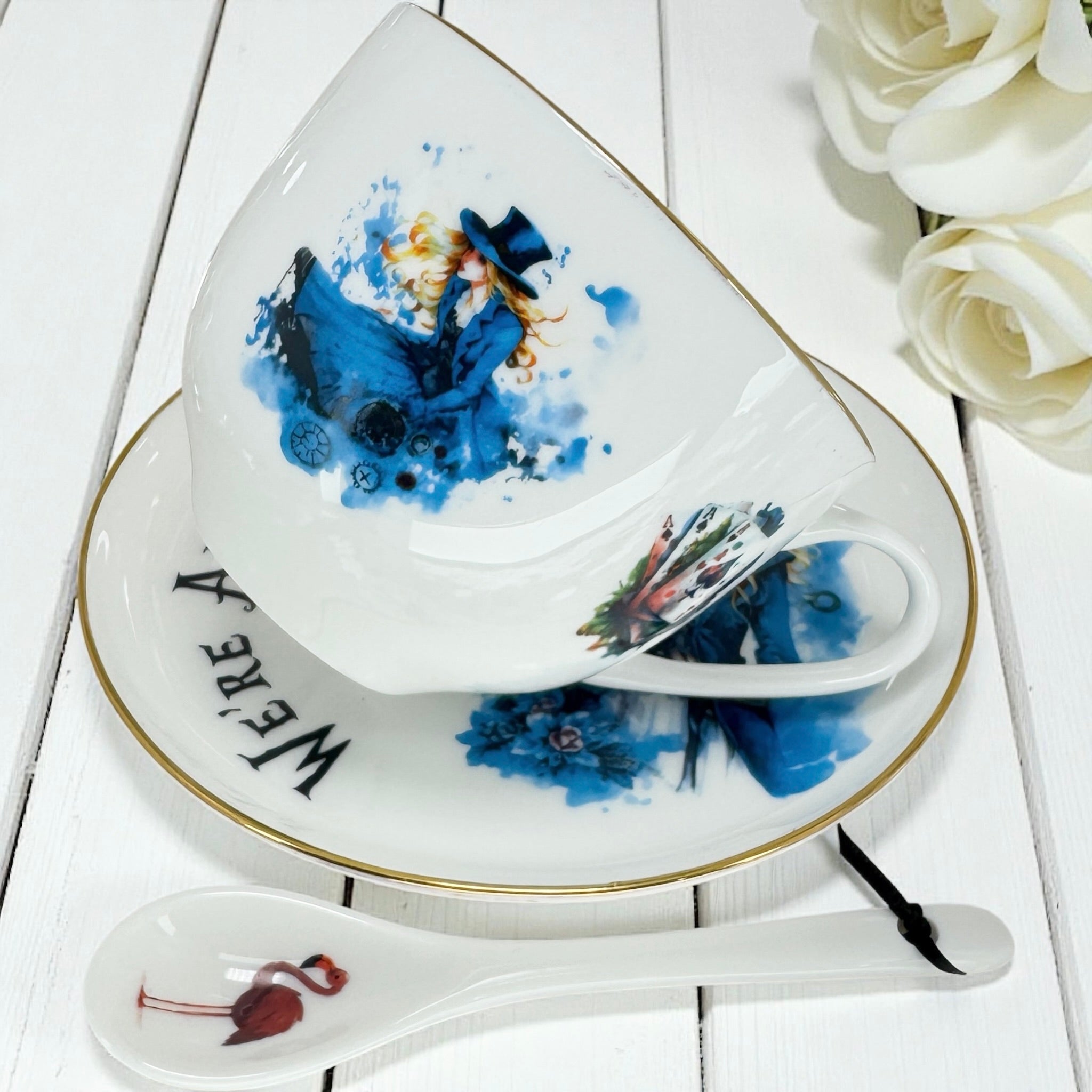 Full set view of Alice in Wonderland Teacup, Saucer, and Flamingo Spoon, with included Black Tea Reading blend sample.