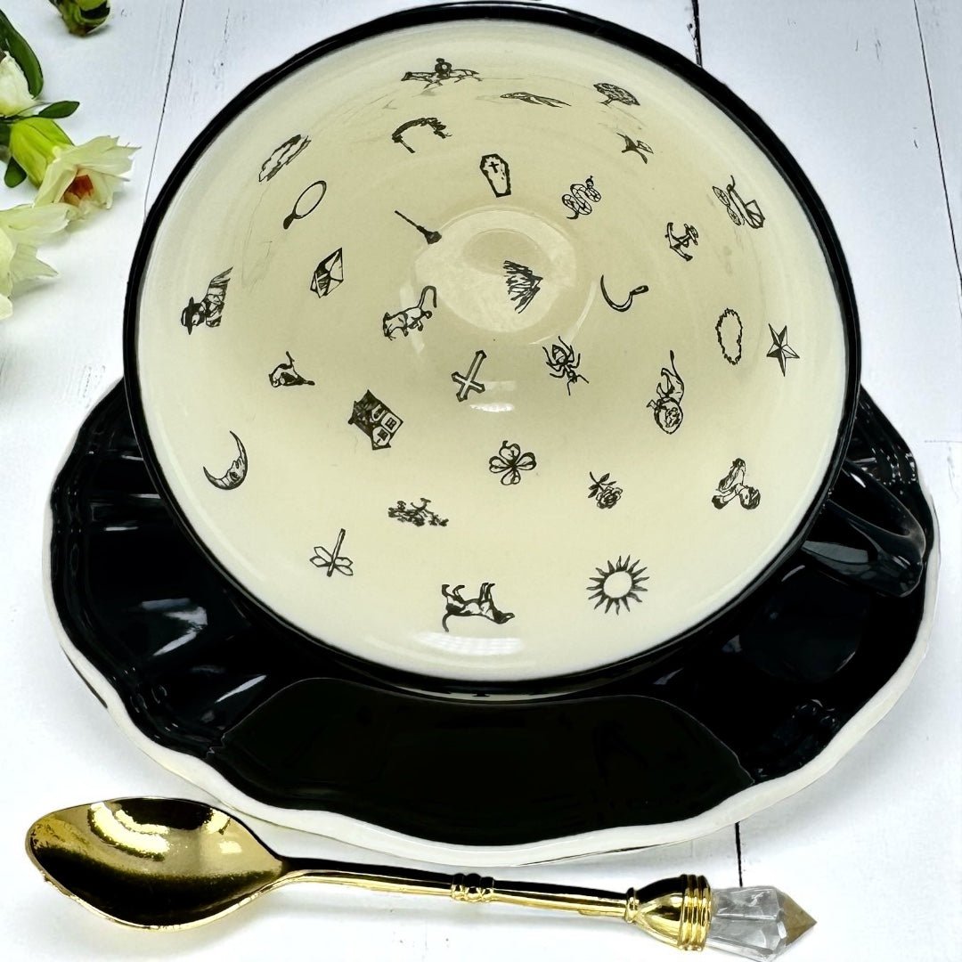 Internal view of tea leaf reading teacup with black designs on a white background