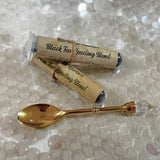 Gold teaspoon and tea samples. 
