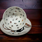 Whimsical cat-themed teacup and saucer set for tea leaf reading and mystical practices