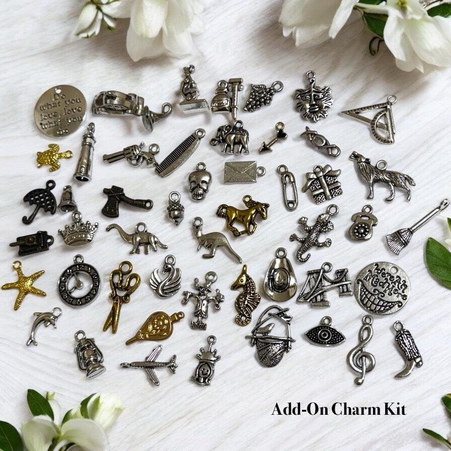 Set of 50 mixed metal charms in gold, silver, and bronze, designed for charm casting and divination, with printed PDF casting sheets and charm meanings guide