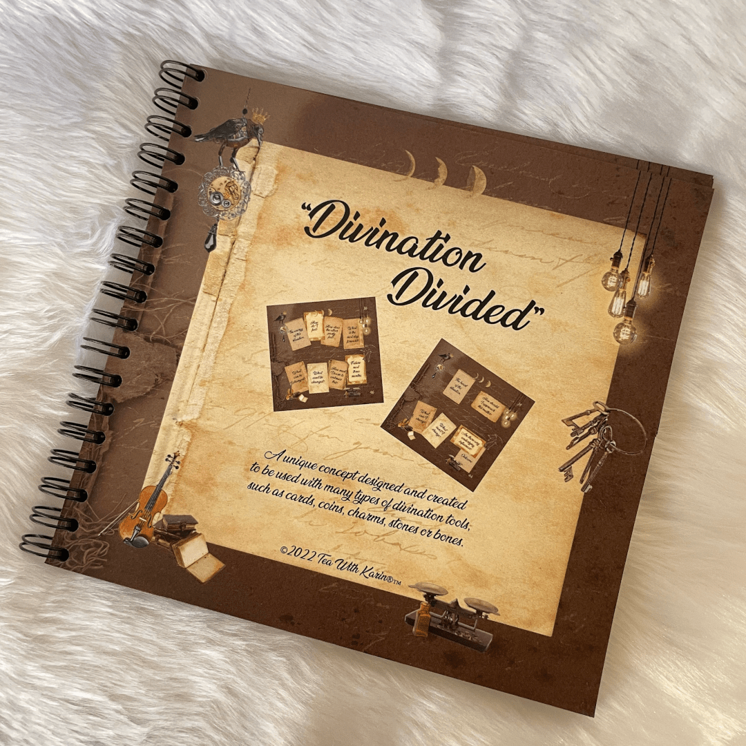 Notebook titled 'Divination Divided' on a textured surface