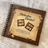 Notebook titled 'Divination Divided' on a textured surface