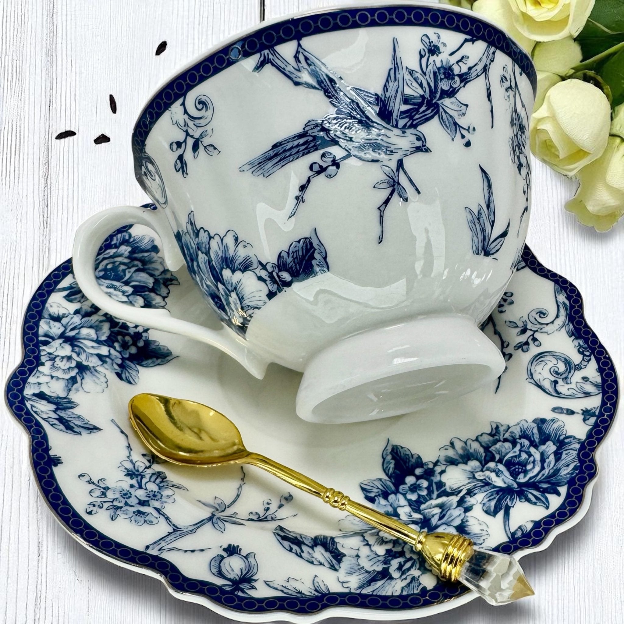 Artistic shot highlighting the delicate blue bird design on the tea set