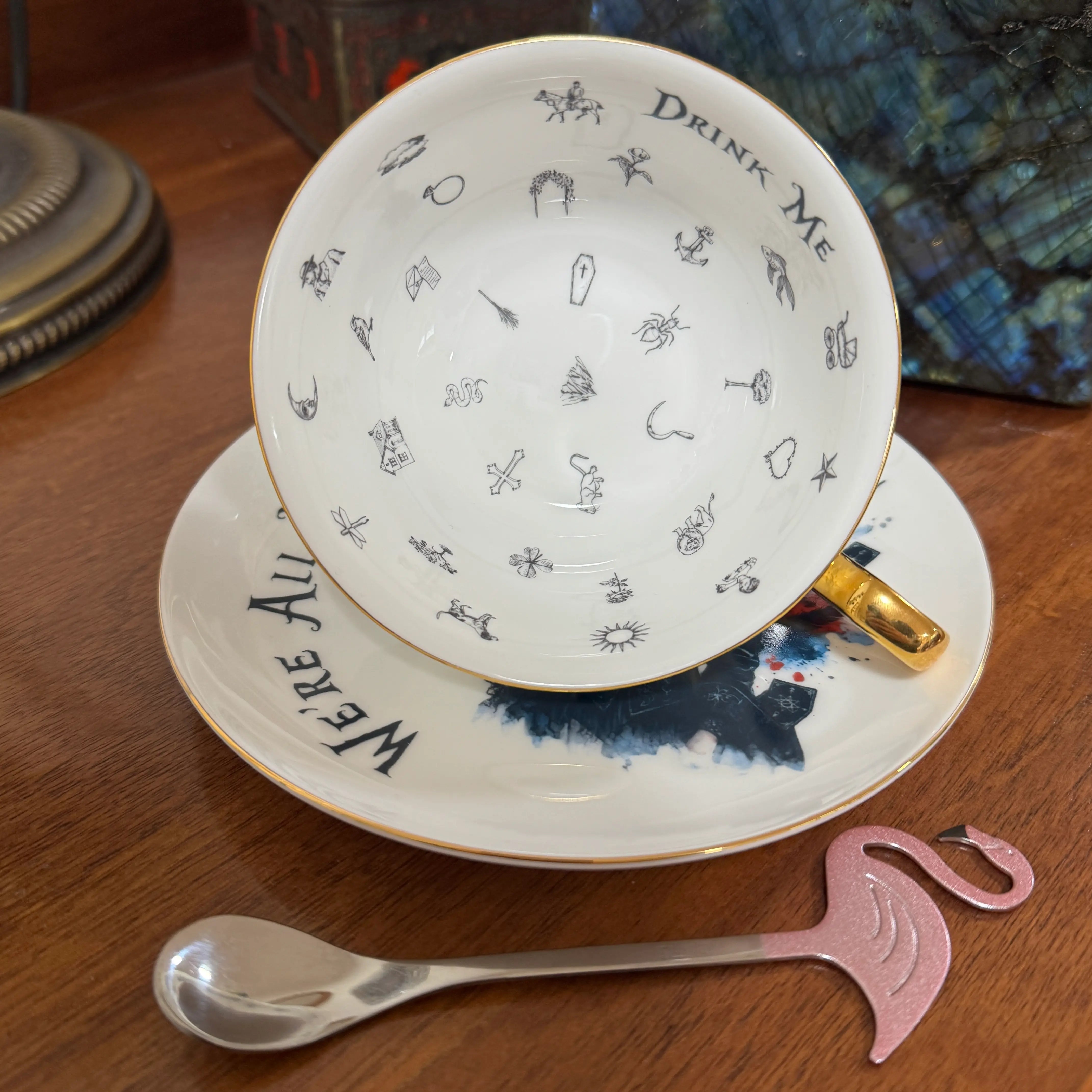 Inside the gothic Alice fortune teller teacup showing 32 tea leaf reading symbols and Drink Me lettering