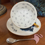 Inside the gothic Alice fortune teller teacup showing 32 tea leaf reading symbols and Drink Me lettering