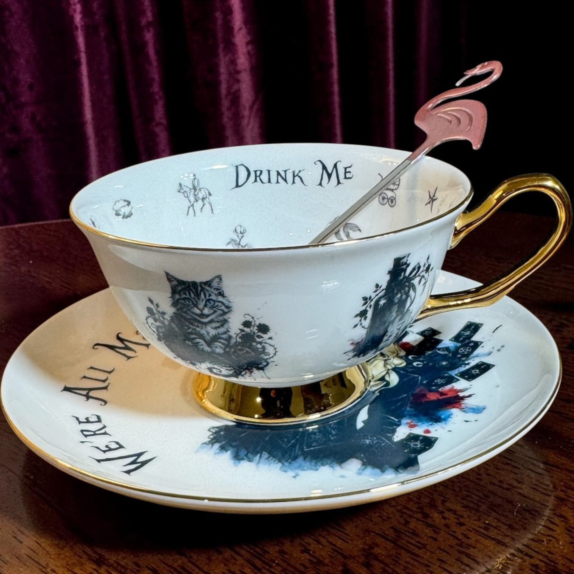 Gothic Alice teacup on saucer showing the Cheshire Cat, Drink Me inside the rim and 24ct gold handle