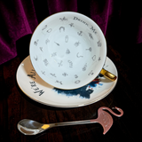 Inside the gothic Alice fortune teller teacup showing 32 tea leaf reading symbols and Drink Me lettering
