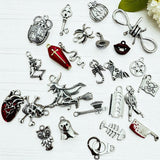 Collection of various silver charms on a white background