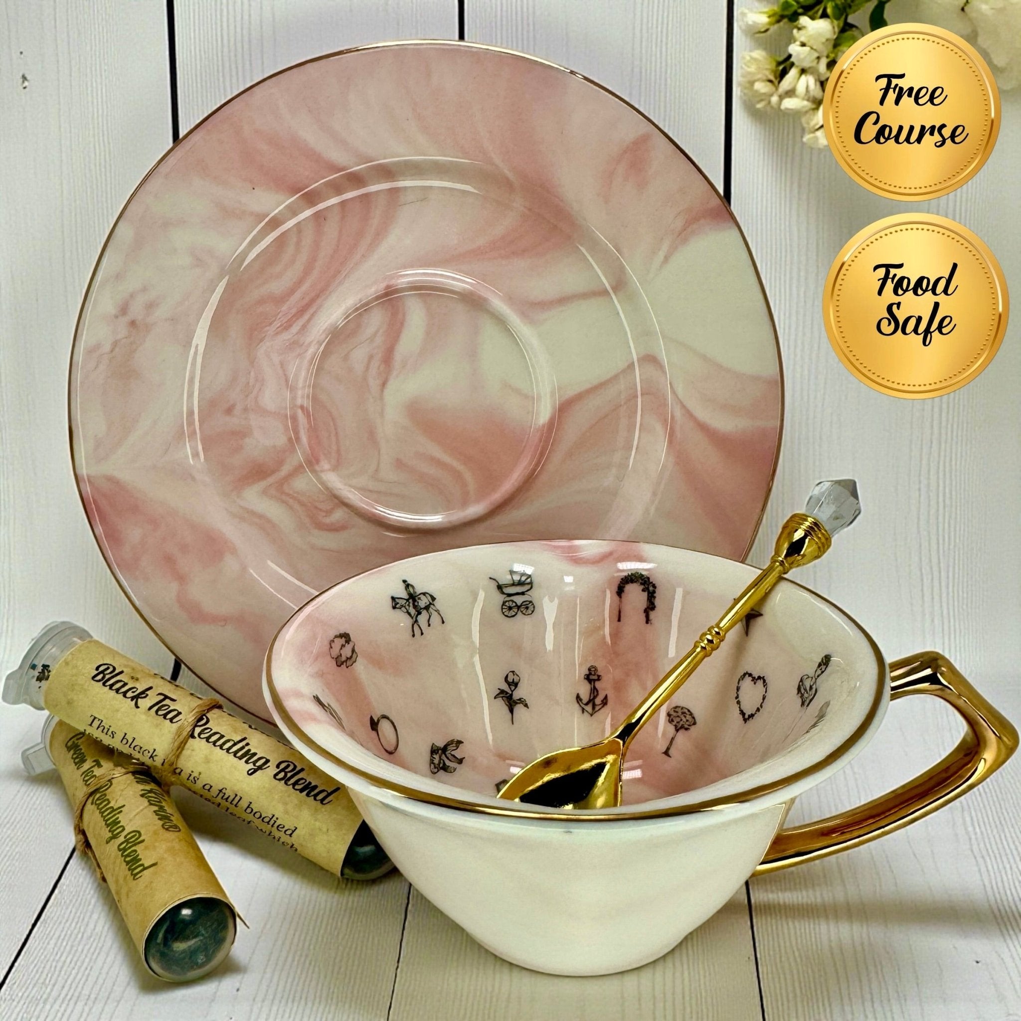 Pink marble fortune telling teacup, saucer, gold spoon, and two black tea blend sample tubes.