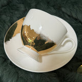 Luxury teacup with a heart-shaped design that appears when tea is poured, featuring permanent gold accents and intricate symbols inside, perfect for tea leaf reading and divination.