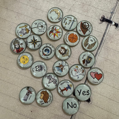 22 major arcana tarot buttons. These make a great gift for an occult lover and you can mix them up in your charm casting tools. They make a great addition to layering over your tarot card readings. Great gift idea.