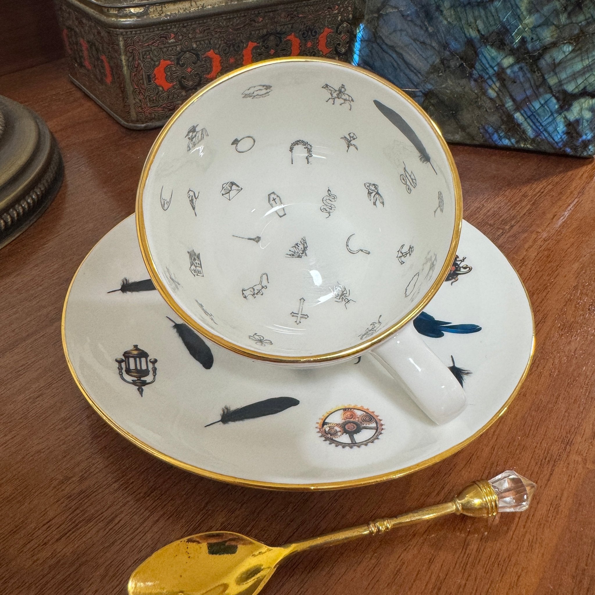 Steampunk Crow Tea Party Set — inside view of 24CT gold raven teacup showing tasseography symbols with saucer and gold spoon | Tea Leaf Reader