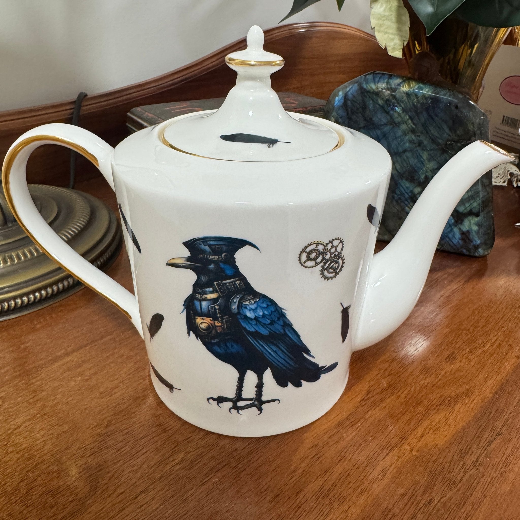 Steampunk Crow Tea Party Set — 24CT gold raven teapot right side view with steampunk crow design on wooden surface | Tea Leaf Reader