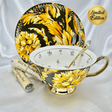 Black and gold fortune telling teacup and saucer set with gold teaspoon and two sample tea tubes