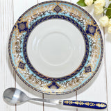 Close-up view of the intricate gold detailing on the rim of the elegant Persian divination saucer.