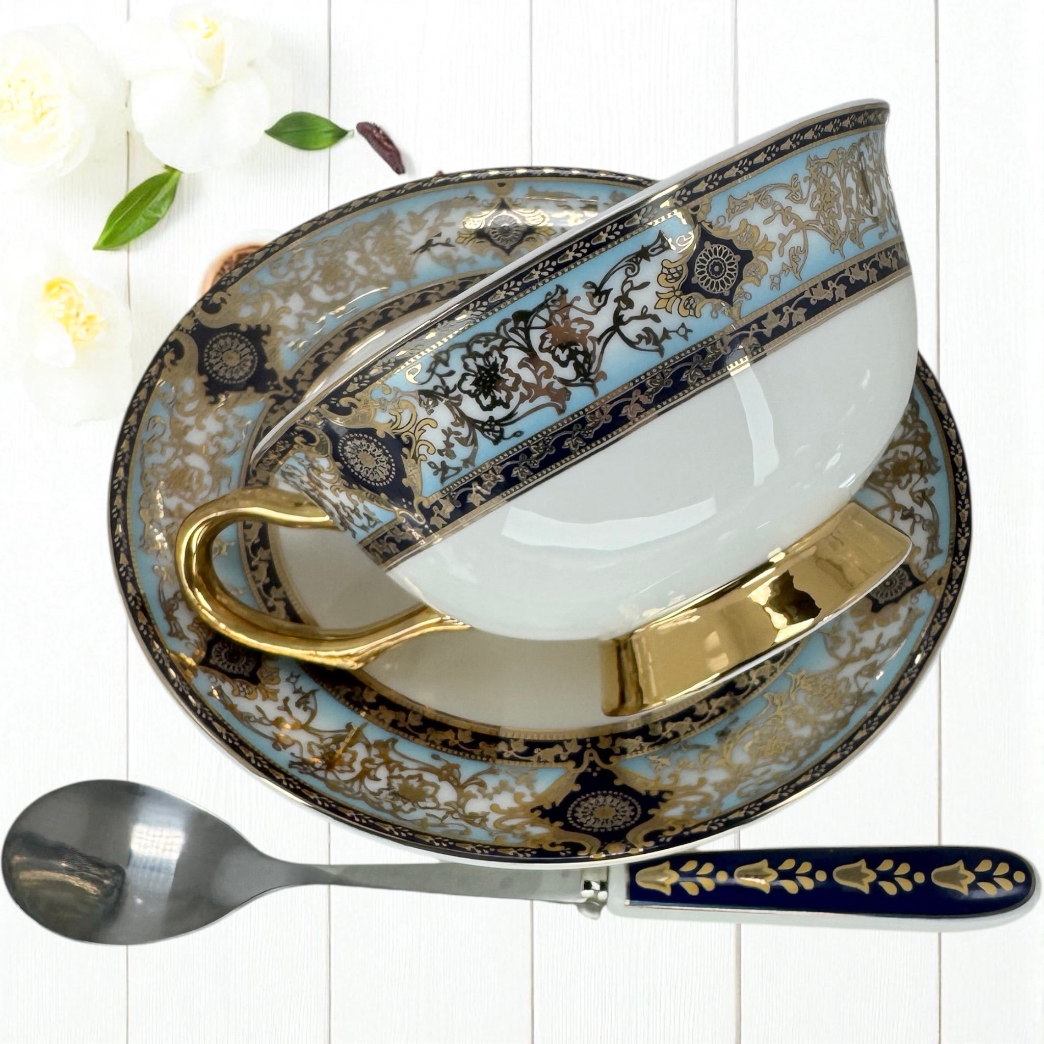 Detailed shot of the Persian-patterned saucer and matching teaspoon from the tea leaf reading kit.