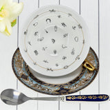Complete three-piece tea leaf reading set: luxury blue teacup, saucer, and matching gold-handled teaspoon