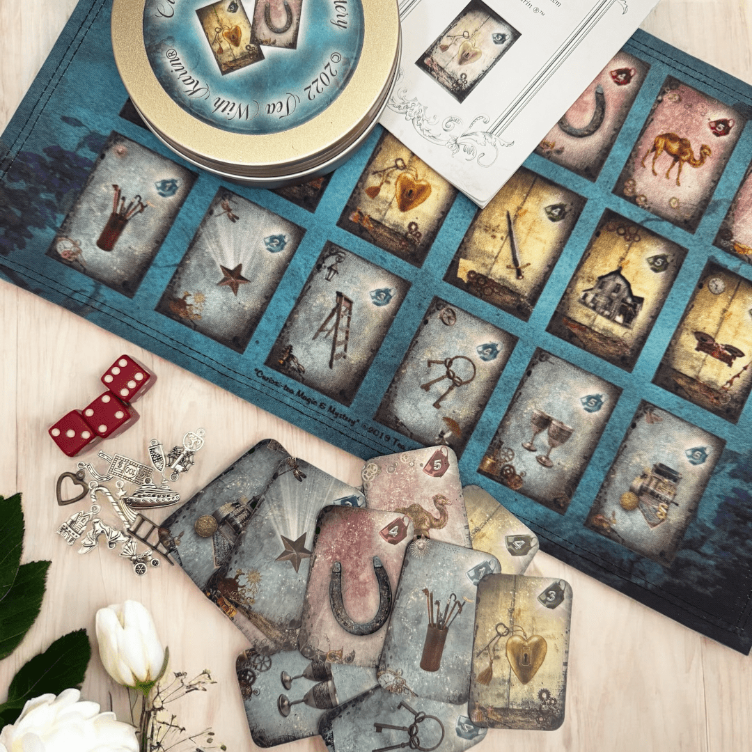 Magic & Mystery. This is a full divination system all in one travel kit tin.  It has washable spandex mat and 18 cards and 18 charms and 3 dice.