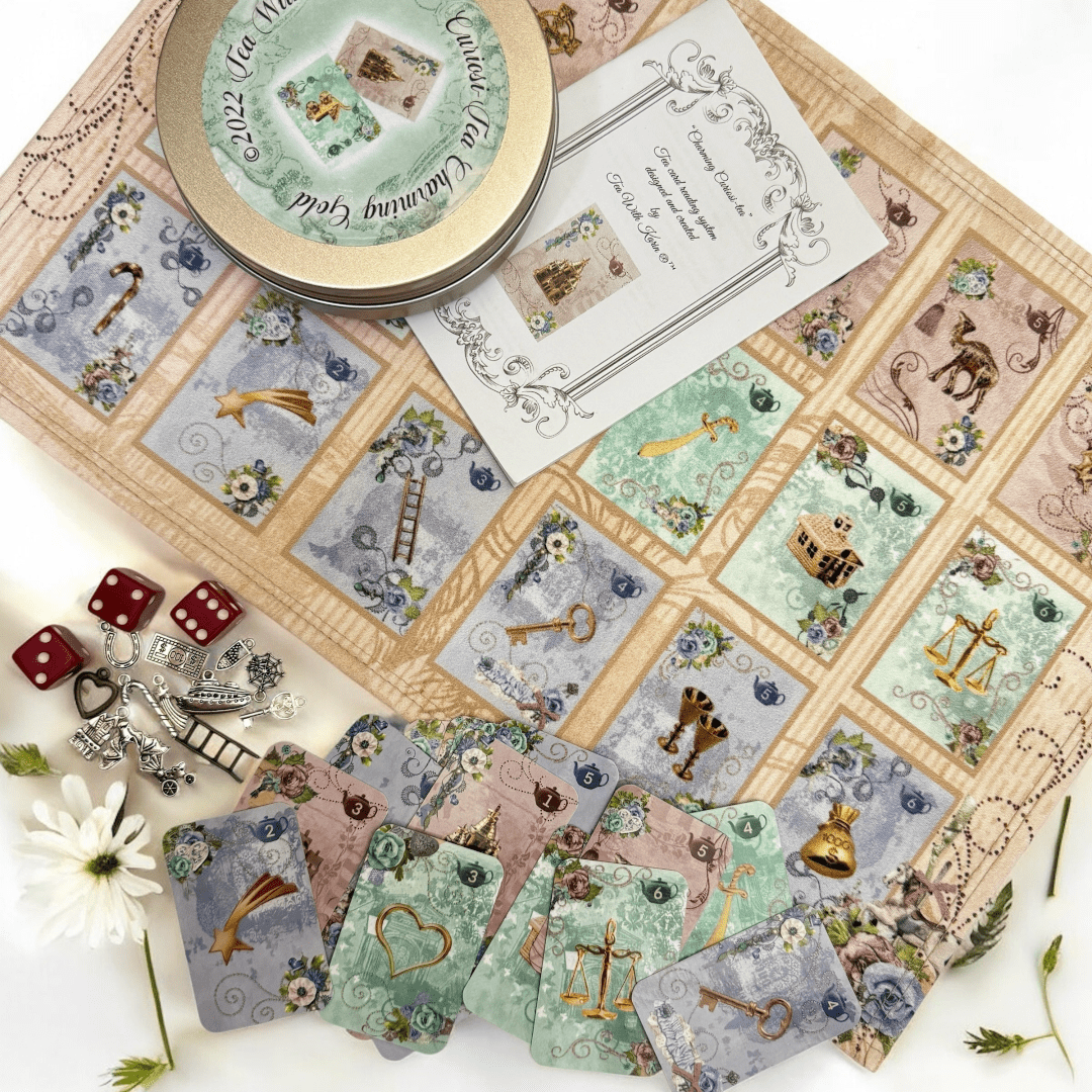 Charming Curiosi-tea forecasting system. This is a full divination system all in one travel kit tin.  It has washable spandex mat and 18 cards and 18 charms and 3 dice.