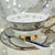 Ornate Persian tasseography teacup set featuring intricate blue and gold ceramic patterns.