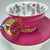 Video showcasing the full Alice in Wonderland teacup and saucer set, including the internal fortune telling symbols and external hot pink colour