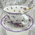 Close-up of the lavender-tinged teacup rim and delicate pattern
