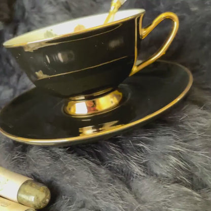 Black and gold teacup. Tarot Major Arcana symbols inside teacup to learn the easy way of tea leaf reading. FREE course.