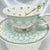 Video rotating the tea cup and saucer set, showcasing the scalloped pattern exterior and the detailed tea leaf reading symbols inside.
