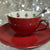 Deep red teacup with silver platinum rim and matching saucer, featuring 22 Major Arcana Tarot symbols inside, perfect for tea leaf reading and divination.