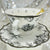 Close-up of the intricate embossed bird design on the black and white tea cup
