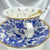 Video rotating the blue and white teacup set, showcasing the external bird and floral pattern and the small black divination symbols inside the cup.
