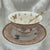 Luxury gold-accented teacup with permanent symbols inside, perfect for tea leaf reading and divination, curated by Karin in her home studio