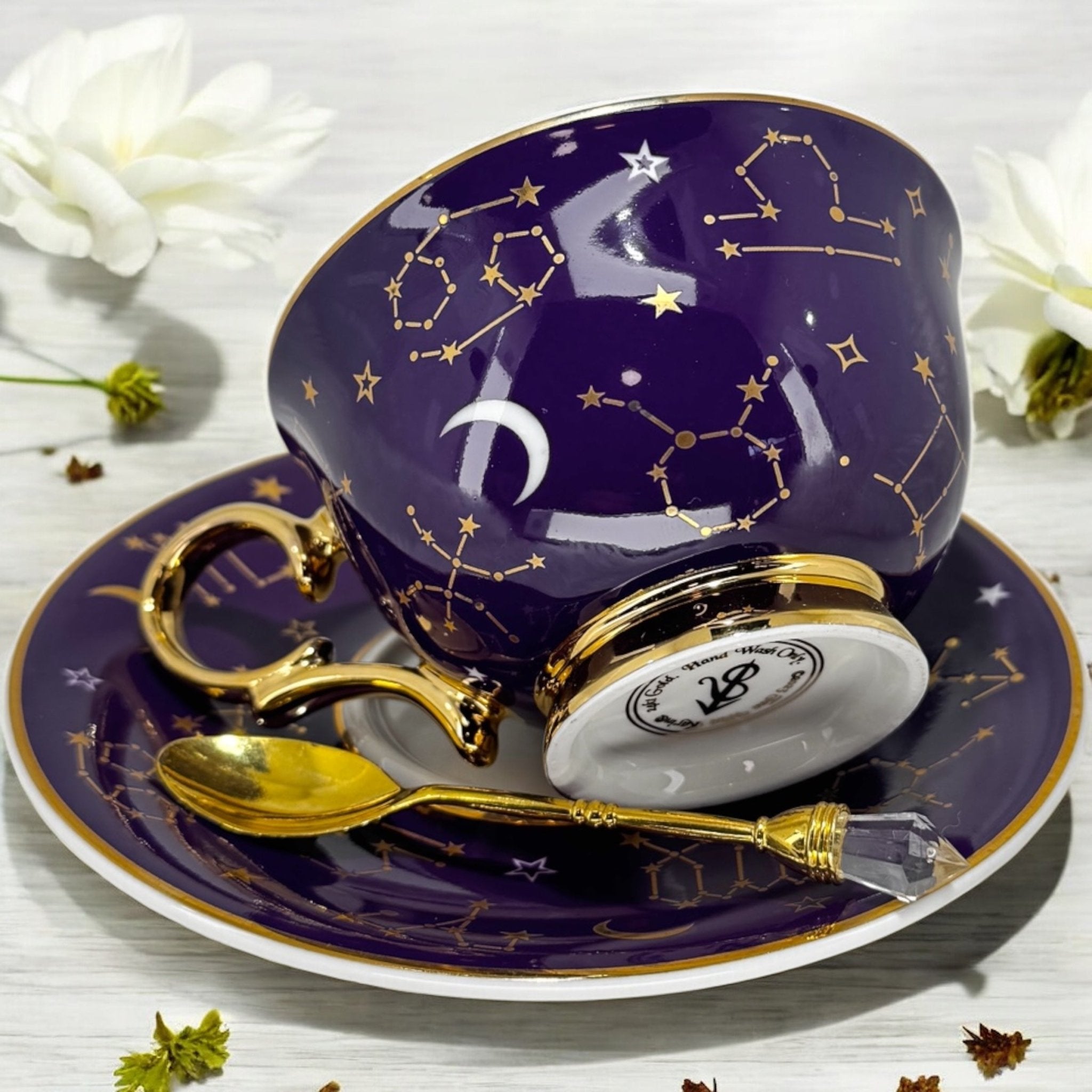 Luxury gold-accented teacup with permanent symbols inside, perfect for tea leaf reading and divination, curated by Karin in her home studio."