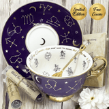 Purple fortune telling teacup with gold accents and celestial designs on a wooden surface with books and flowers.