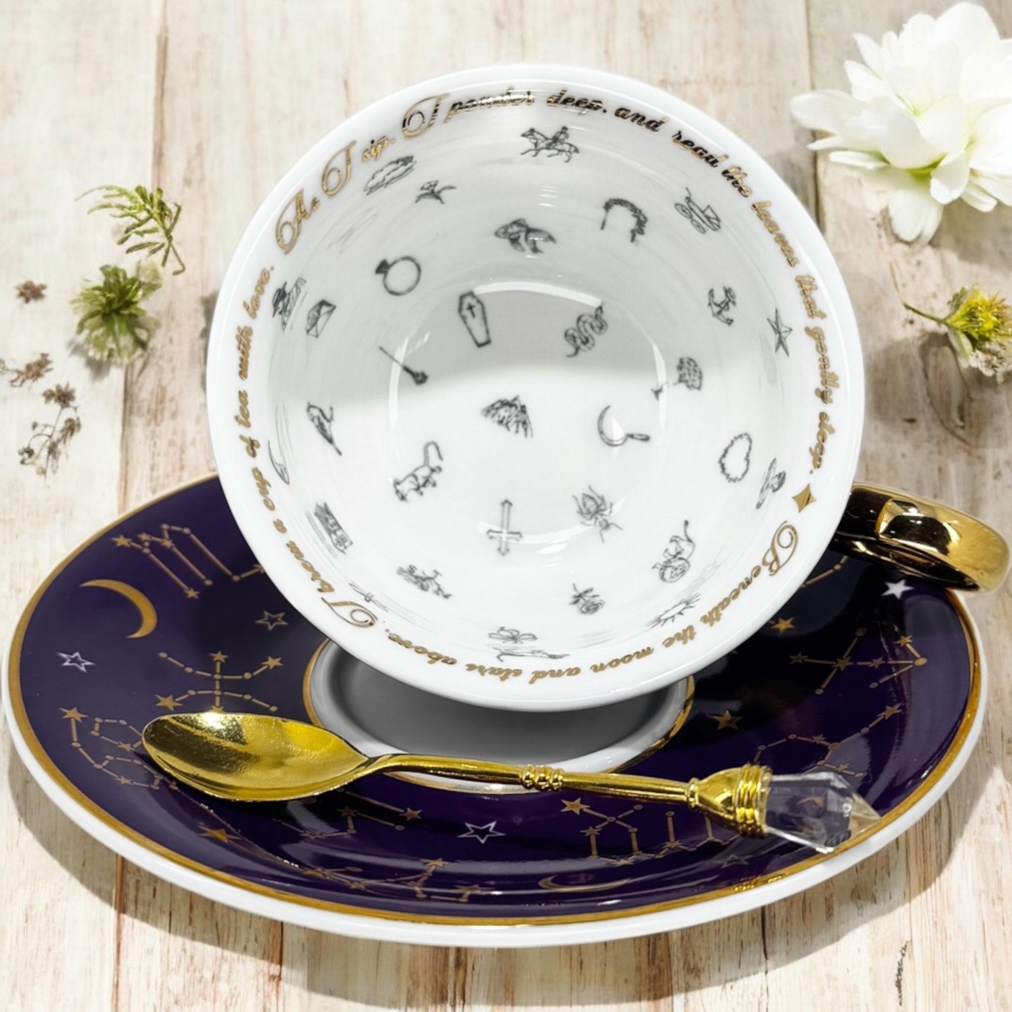 Luxury gold-accented teacup with permanent symbols inside, perfect for tea leaf reading and divination, curated by Karin in her home studio."