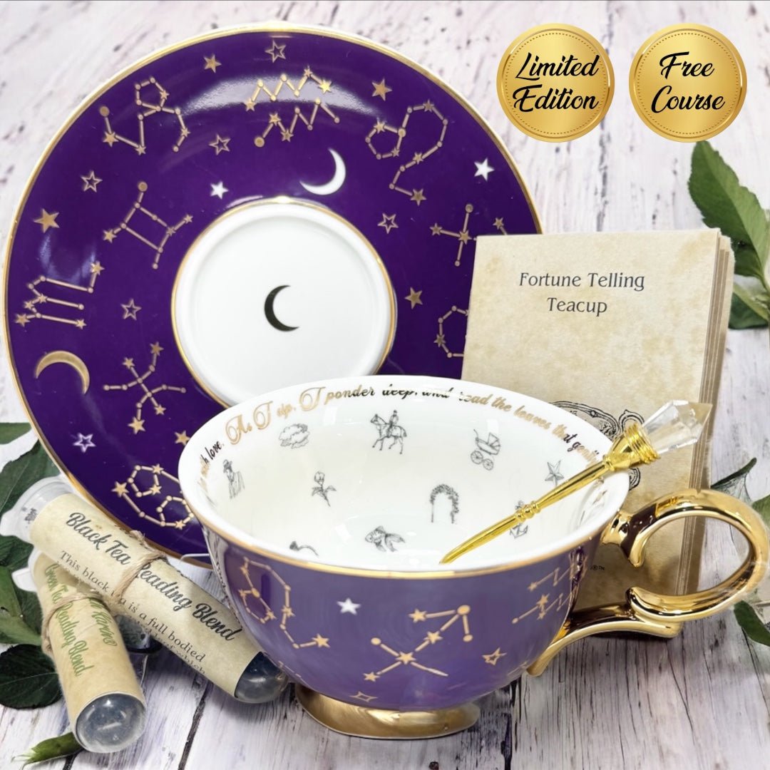 Purple teacup with gold accents and star constellations, next to a purple saucer and book titled 'Fortune Telling Teacup'.