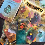 A beautiful 52-card tea leaf reading deck with vibrant watercolor-style illustrations, displayed alongside a soft cotton drawstring bag and a small gold teaspoon. 