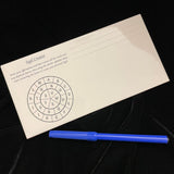 Ceramic Sigil Creator tile shown at an angle on a wooden surface