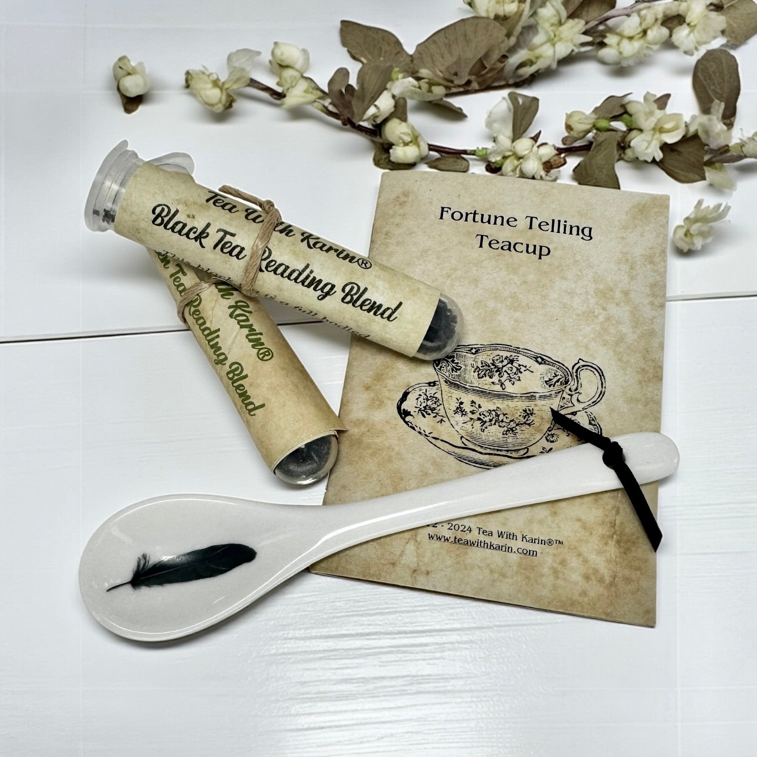 Tea packaging with a spoon and decorative card on a white background