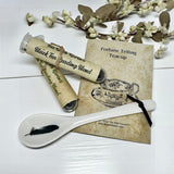 Tea packaging with a spoon and decorative card on a white background
