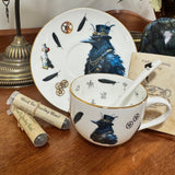 Tea cup with decorative design, spoon, and tea packaging on a wooden surface.