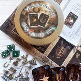 This is a complete divination tool kit all in one. Unique kit based on tea leaf reading symbols. Uses cards, dice, and charms for fortune telling your future. Much more simple than tarot card reading. Comes in tin perfect gift for friend Mom women.