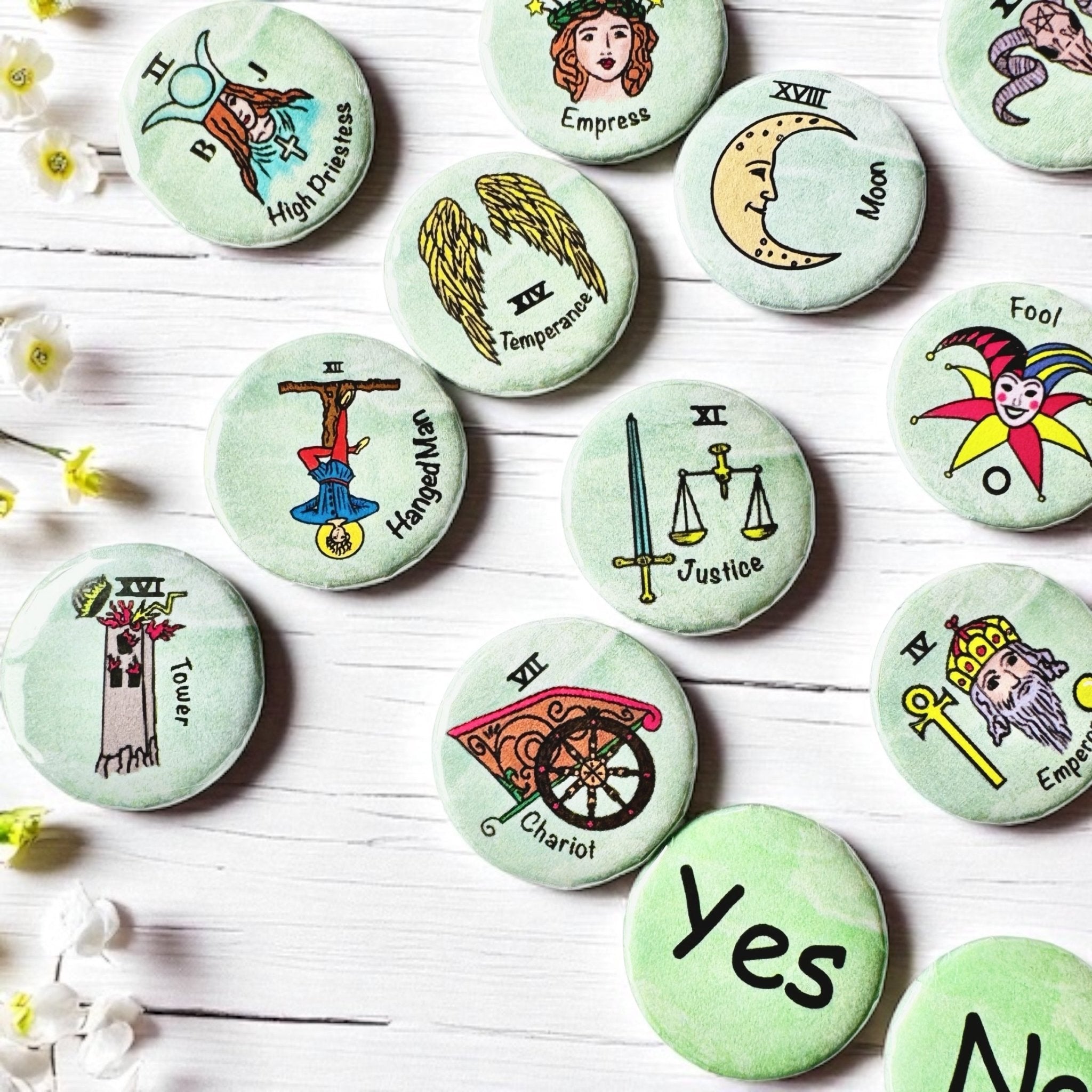 Set of 1-inch tarot buttons featuring the Major Arcana images on a pale mint green background, protected by a clear plastic coating, ideal for tarot, charm casting, and discreet divination in everyday settings