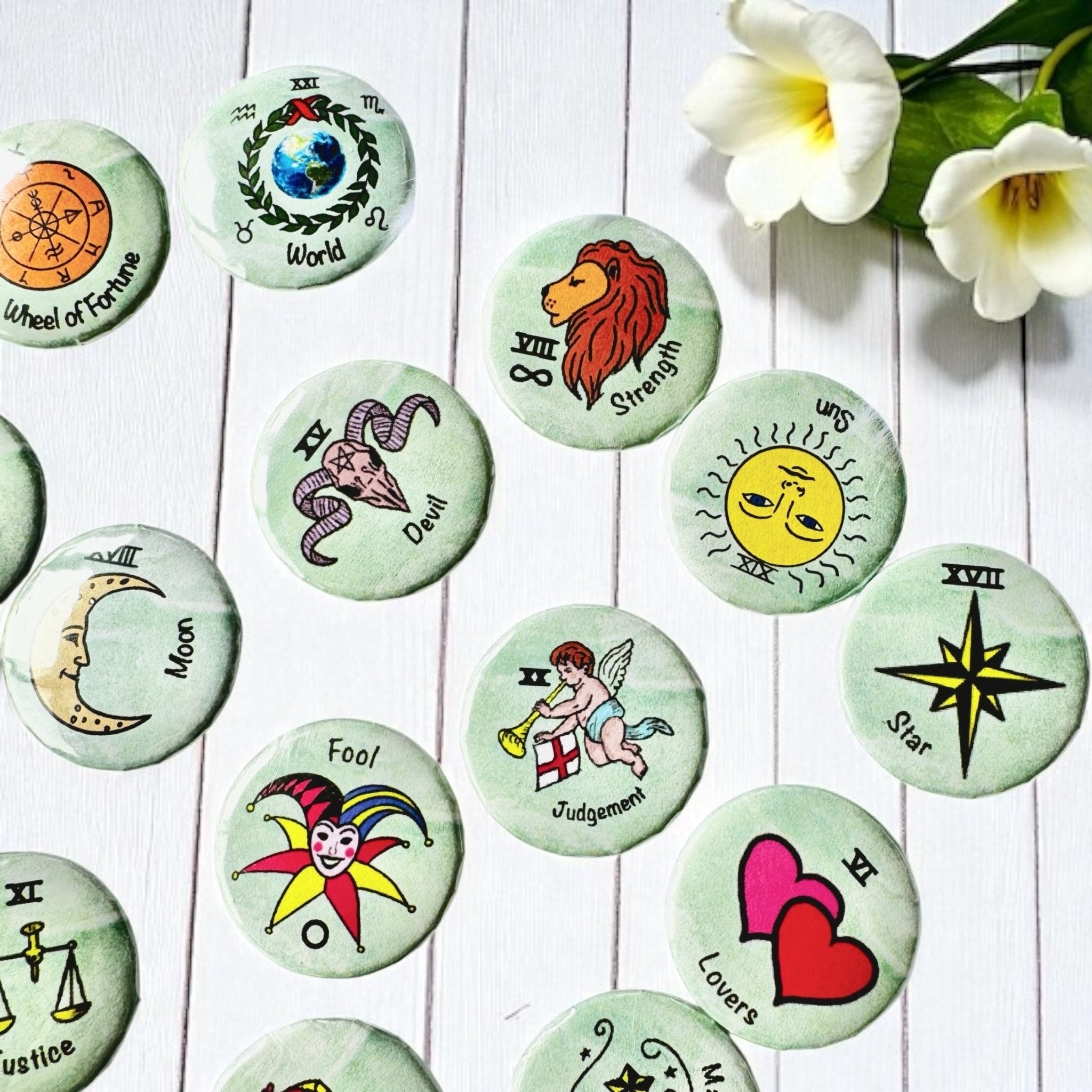 Set of 1-inch tarot buttons featuring the Major Arcana images on a pale mint green background, protected by a clear plastic coating, ideal for tarot, charm casting, and discreet divination in everyday settings