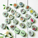 Set of 1-inch tarot buttons featuring the Major Arcana images on a pale mint green background, protected by a clear plastic coating, ideal for tarot, charm casting, and discreet divination in everyday settings